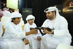H.H. Sheikh Mubarak Bin Nahyan Bin Mubarak Al Nahyan tries the trigger of a Miniature Arsenal half size Kalashnikov.